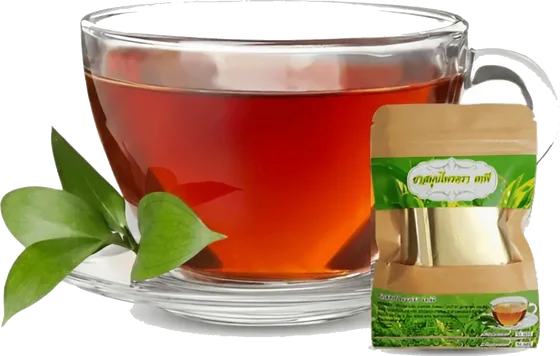 A glass cup of deep red-amber Thai herbal tea with fresh green leaves