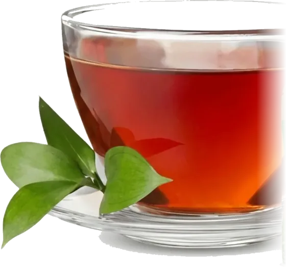 Close view of a glass cup of deep red-amber Thai herbal tea with fresh green leaves
